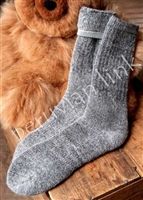 Warm woolen sock on rustic table
