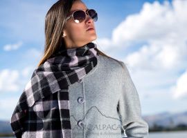 Woman wearing sunglasses and plaid scarf