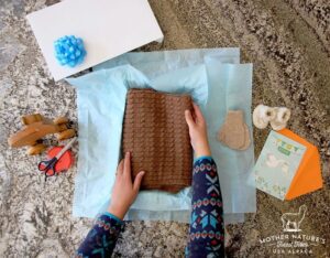 Brown sweater with card and mittens
