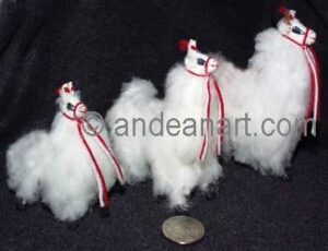 Three alpaca figurines with red ribbons