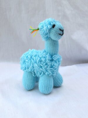 Blue knitted llama toy on white background.