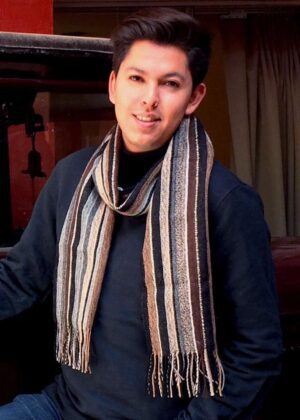 Man wearing striped scarf and dark sweater
