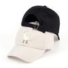 Black and beige baseball caps stacked