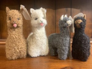 Cute stuffed alpacas in a row