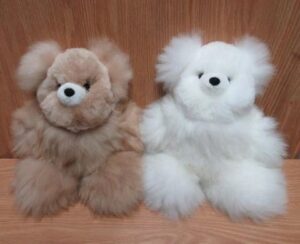Fluffy teddy bears on wooden background