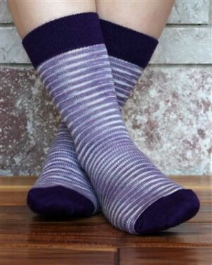 Striped purple socks on wooden floor