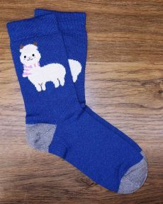 Cozy llama-themed socks on wooden floor