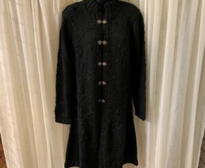Black knitted coat with decorative buttons