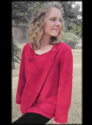 Blonde woman in red sweater outside