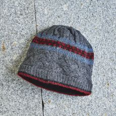 Gray knit beanie with red and blue stripes.