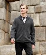 Man in casual attire by stone wall