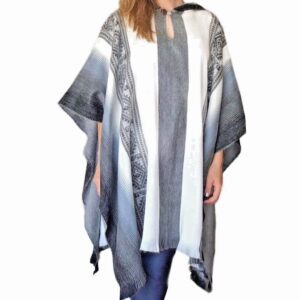 Woman wearing stylish striped poncho