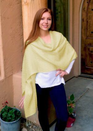 Woman wearing yellow shawl by door
