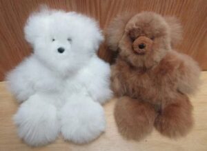 Soft, cuddly teddy bears on wooden surface