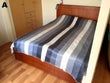 Wooden bed with striped bedding