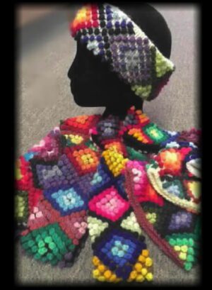Colorful crocheted hat and matching scarf displayed on a mannequin head.
