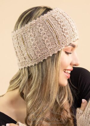 Smiling woman wearing a cozy knitted beige headband.