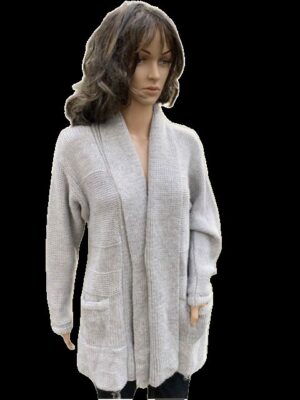 Woman wearing a light gray cardigan sweater with long sleeves.