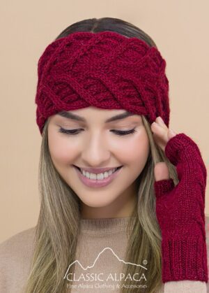 Smiling woman wearing a red knit hat and matching fingerless gloves.