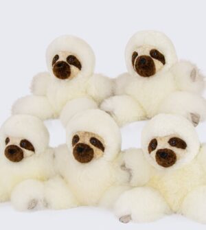 Group of six fluffy white teddy bears with brown noses and eyes.