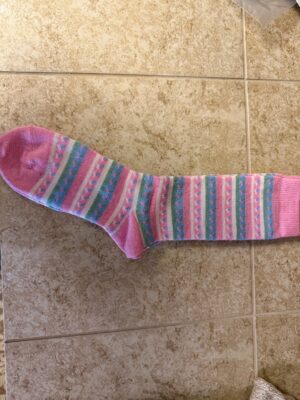 Pink striped knee sock on tile floor